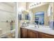 Well-lit bathroom featuring a glass-door shower, updated vanity, and decorative accents at 9576 W Blue Sky Dr, Peoria, AZ 85383