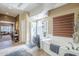 Bright bathroom featuring a soaking tub, glass enclosed shower, and tile flooring at 9576 W Blue Sky Dr, Peoria, AZ 85383