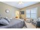 Cozy bedroom with natural light, plantation shutters, and inviting decor at 9576 W Blue Sky Dr, Peoria, AZ 85383