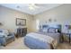 Bedroom with neutral decor, comfortable seating, ceiling fan, and a decorative mirror at 9576 W Blue Sky Dr, Peoria, AZ 85383
