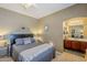 Comfortable bedroom with en-suite bathroom access, neutral decor, and ample natural light at 9576 W Blue Sky Dr, Peoria, AZ 85383