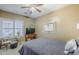 Bedroom with plantation shutters, ceiling fan, and tasteful decor at 9576 W Blue Sky Dr, Peoria, AZ 85383