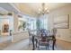 Elegant dining room with a marble-top table, ornate chairs, and stylish chandelier lighting at 9576 W Blue Sky Dr, Peoria, AZ 85383