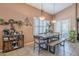 The dining room has a long, wooden table with a built-in hutch and bright windows at 9576 W Blue Sky Dr, Peoria, AZ 85383