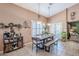 The dining room features a wooden table, complemented by a coffee bar and bright, shuttered windows at 9576 W Blue Sky Dr, Peoria, AZ 85383