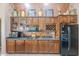 The kitchen has wooden cabinets with granite countertops, modern appliances, and a refrigerator at 9576 W Blue Sky Dr, Peoria, AZ 85383