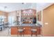 A kitchen with granite countertops, ample storage, and a view of the dining room at 9576 W Blue Sky Dr, Peoria, AZ 85383