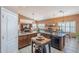 An open kitchen layout, with granite countertops and seamlessly connected to the living room for entertainment at 9576 W Blue Sky Dr, Peoria, AZ 85383