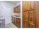 Convenient laundry room features ample storage cabinets, counter space, and modern washer at 9576 W Blue Sky Dr, Peoria, AZ 85383