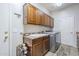 Laundry room features storage cabinets, a utility sink, and modern appliances at 9576 W Blue Sky Dr, Peoria, AZ 85383
