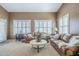 Cozy living room featuring plush seating and bright shuttered windows at 9576 W Blue Sky Dr, Peoria, AZ 85383