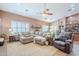 Bright living room with a large sectional sofa and comfortable leather chair at 9576 W Blue Sky Dr, Peoria, AZ 85383