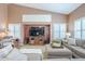 Cozy living room with a large TV and lots of natural light from shuttered windows at 9576 W Blue Sky Dr, Peoria, AZ 85383