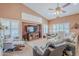 The living room features vaulted ceilings, shutters, neutral tones, and comfortable seating arrangement at 9576 W Blue Sky Dr, Peoria, AZ 85383