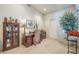 Dedicated office space with a wooden desk, display cabinet, and carpet flooring for a comfortable work environment at 9576 W Blue Sky Dr, Peoria, AZ 85383