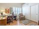 Office space featuring a desk, chair, wood flooring, and ample storage at 9576 W Blue Sky Dr, Peoria, AZ 85383