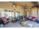 Inviting outdoor patio features comfortable seating, ceiling fans, and a cozy fire pit at 9576 W Blue Sky Dr, Peoria, AZ 85383