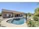 Beautiful pool and spa area complemented by lush landscaping and a spacious patio at 9576 W Blue Sky Dr, Peoria, AZ 85383