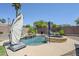 Relaxing backyard pool and spa area surrounded by lush greenery and desert landscaping at 9576 W Blue Sky Dr, Peoria, AZ 85383