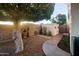 Secluded backyard with mature tree, rock garden, water feature, and storage shed at 9721 E Juanita Ave, Mesa, AZ 85209
