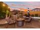Inviting backyard with a fire pit, outdoor kitchen and beautiful sunset views at 9721 E Juanita Ave, Mesa, AZ 85209