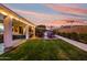 Spacious backyard with lush lawn, covered patio, outdoor seating, and built-in BBQ area, perfect for entertaining at 9721 E Juanita Ave, Mesa, AZ 85209