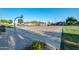 Outdoor community basketball court surrounded by beautiful landscaping and grass at 9721 E Juanita Ave, Mesa, AZ 85209