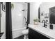 Bright bathroom with a tub and shower, a white countertop vanity, and a modern black faucet at 9721 E Juanita Ave, Mesa, AZ 85209
