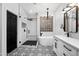 Modern bathroom boasts a glass enclosed shower, soaking tub, black accents, and patterned tile at 9721 E Juanita Ave, Mesa, AZ 85209