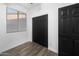 Bright bedroom featuring wood floors, a closet, and a window with blinds for a modern design at 9721 E Juanita Ave, Mesa, AZ 85209