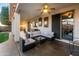 Spacious covered patio with comfortable seating, ceiling fan, and backyard views, ideal for outdoor living at 9721 E Juanita Ave, Mesa, AZ 85209