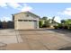 Attached two-car garage featuring light beige paint and long driveway at 9721 E Juanita Ave, Mesa, AZ 85209