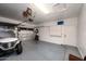 Spacious garage featuring a golf cart, storage cabinets, and convenient overhead door access for easy parking at 9721 E Juanita Ave, Mesa, AZ 85209