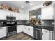 Bright kitchen featuring white cabinets, stainless steel appliances, and a view to the outside at 9721 E Juanita Ave, Mesa, AZ 85209