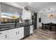 Modern kitchen features stainless steel appliances, gray backsplash, and an eat-in dining space with natural light at 9721 E Juanita Ave, Mesa, AZ 85209