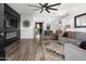 Spacious living room featuring wood floors, a modern fireplace, and abundant natural light at 9721 E Juanita Ave, Mesa, AZ 85209