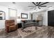 Comfortable living room with ample seating, a ceiling fan, and a neutral color palette at 9721 E Juanita Ave, Mesa, AZ 85209