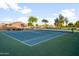 Well-maintained tennis court surrounded by green space and lush trees at 9721 E Juanita Ave, Mesa, AZ 85209