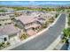 Aerial view of the home featuring a tile roof, solar panels, and lush landscaping at 9856 E Palladium Dr, Mesa, AZ 85212