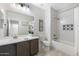 Modern bathroom featuring sleek vanity, tile flooring, and a shower over bathtub combo at 9856 E Palladium Dr, Mesa, AZ 85212