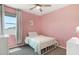 Bright bedroom featuring pink walls, plush bedding, and a window with a view at 9856 E Palladium Dr, Mesa, AZ 85212