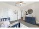 Well-lit bedroom featuring plush carpet, dresser, closet and a ceiling fan at 9856 E Palladium Dr, Mesa, AZ 85212