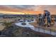 Well-equipped community park with playground equipment, picnic tables, and a scenic view of the mountains at sunset at 9856 E Palladium Dr, Mesa, AZ 85212