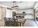 Bright dining area with a modern table, seating for six, and an open kitchen concept at 9856 E Palladium Dr, Mesa, AZ 85212