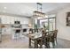 View of open floor plan featuring kitchen with island, dining room, and large sliding doors to patio at 9856 E Palladium Dr, Mesa, AZ 85212