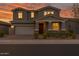Two-story home boasts an attached garage, complemented by manicured landscaping and a cozy entrance at 9856 E Palladium Dr, Mesa, AZ 85212