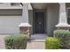Close-up of the home's front entrance, showcasing stone accents and manicured landscaping at 9856 E Palladium Dr, Mesa, AZ 85212