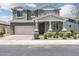 Charming two-story home with a well-maintained front yard, landscaping, and attached garage at 9856 E Palladium Dr, Mesa, AZ 85212