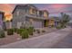 Twilight view of the two-story home, highlighting its charming curb appeal and landscaping at 9856 E Palladium Dr, Mesa, AZ 85212