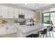 Kitchen boasts a large island with bar seating, modern appliances, and access to the backyard at 9856 E Palladium Dr, Mesa, AZ 85212